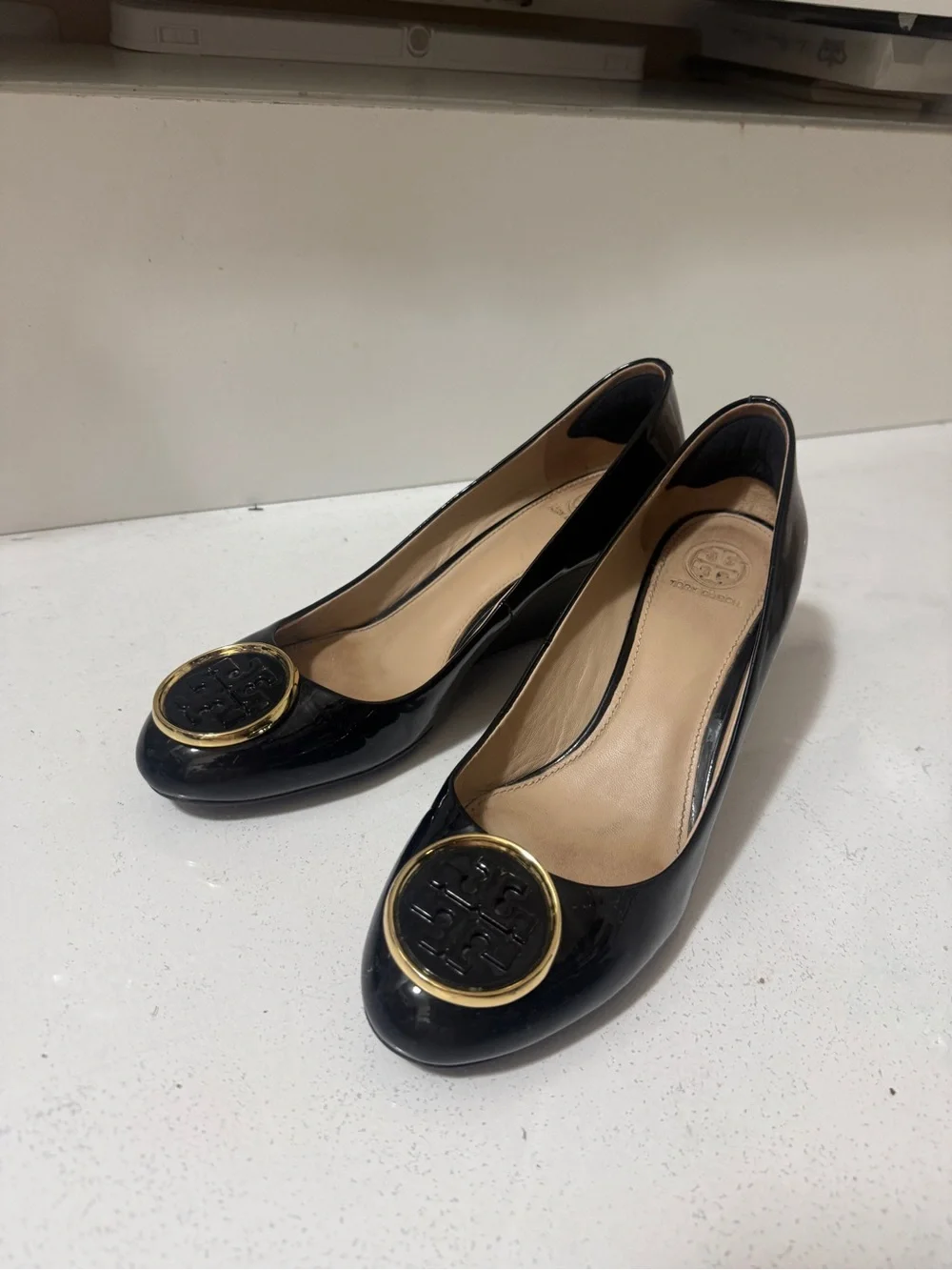 Tory Burch Black Patent Leather Wedge Flats with Gold Logo Medallions